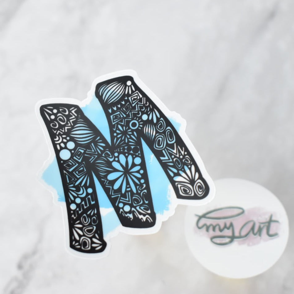 Letter “M” Clear sticker colored Background